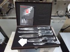 Five piece knife set in wooden box.