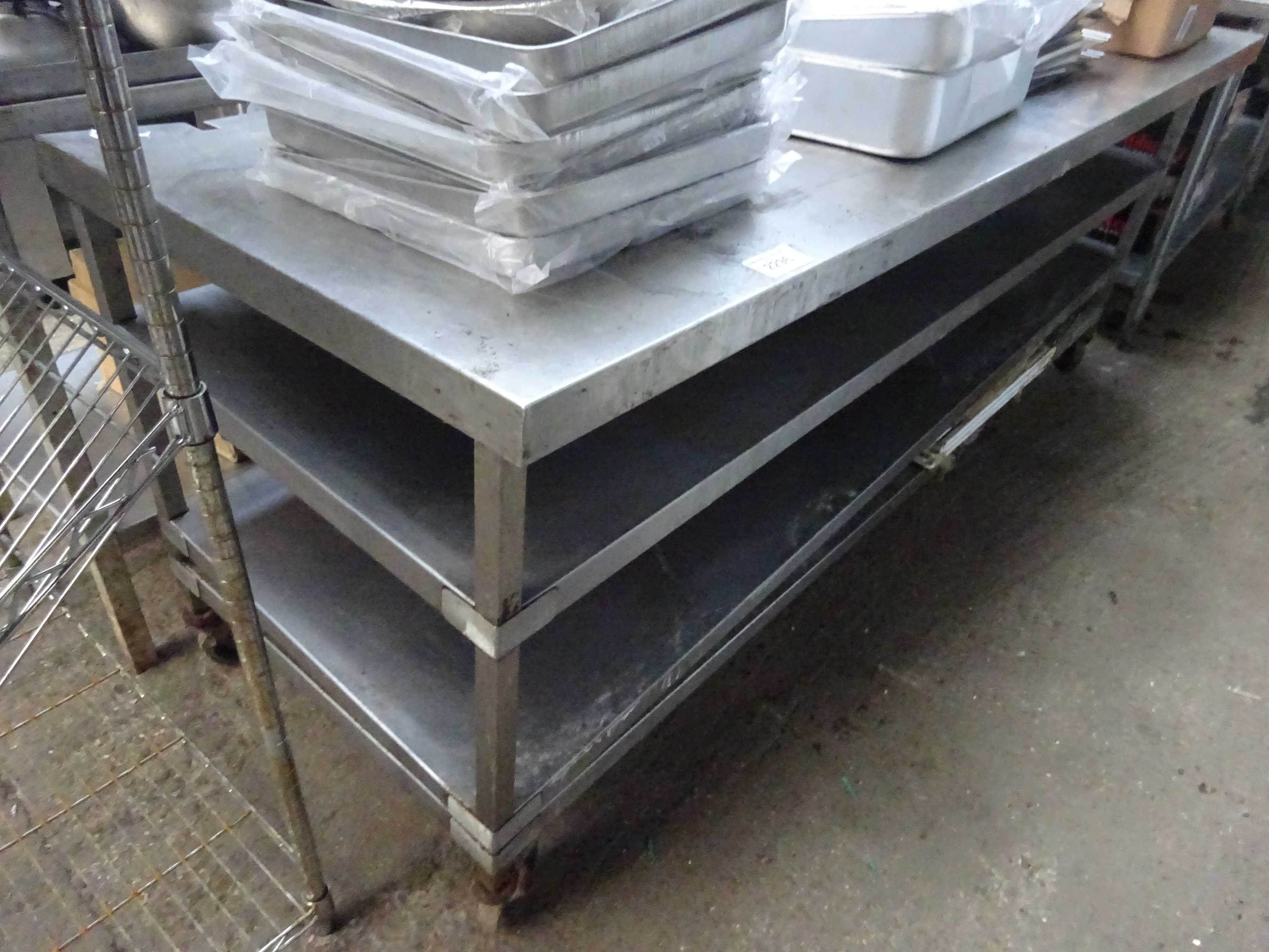 Mobile stainless steel preparation table with three under shelves, 213cms.