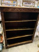 Carved oak open bookcase of four shelves.