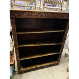 Carved oak open bookcase of four shelves.