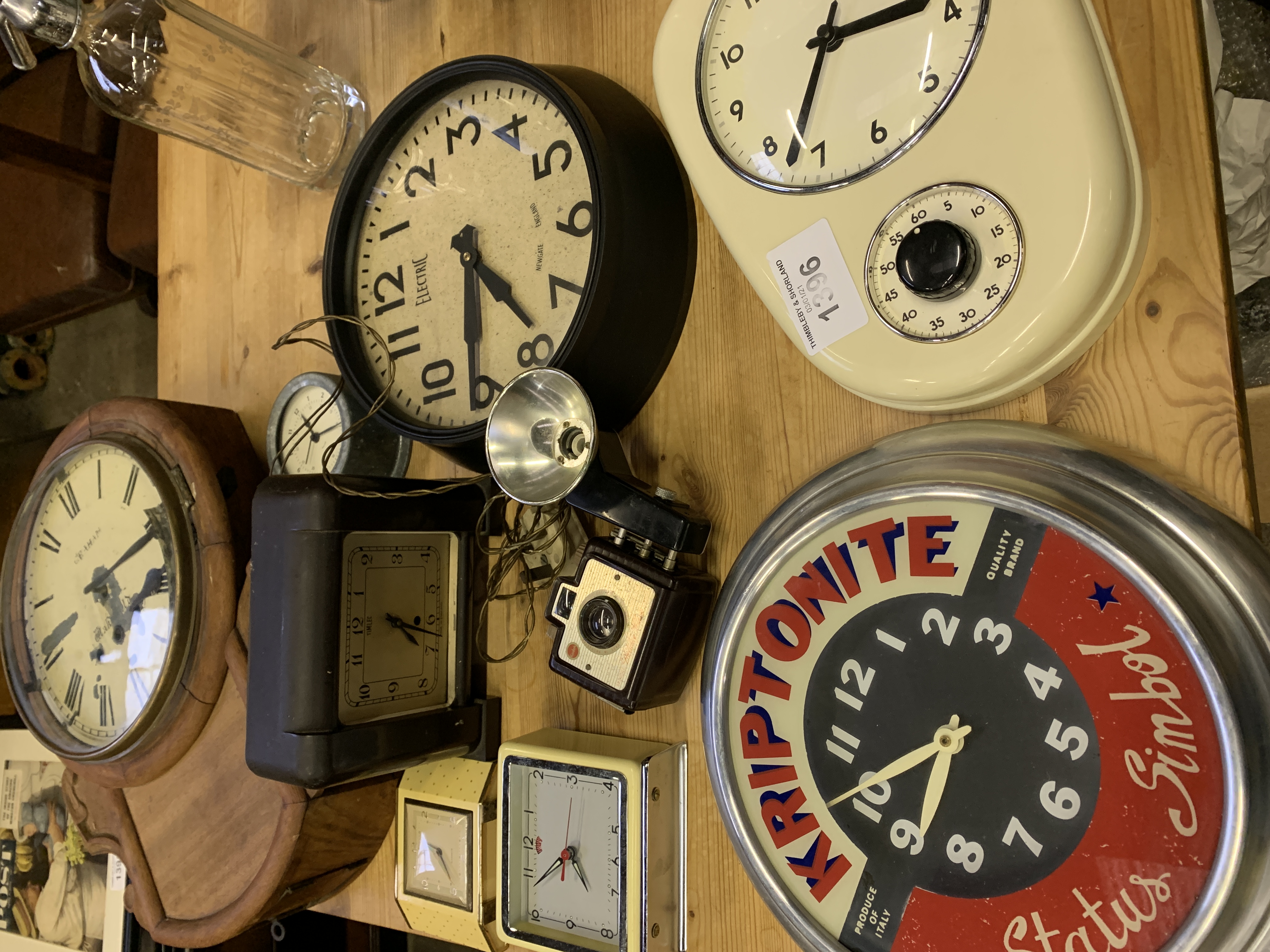 Eight various clocks and a Kodak Brownie Holiday Flash camera.