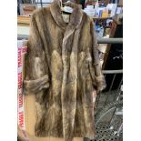 Long pale brown fur coat by Marcus.