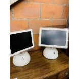 Two Apple iMacs.