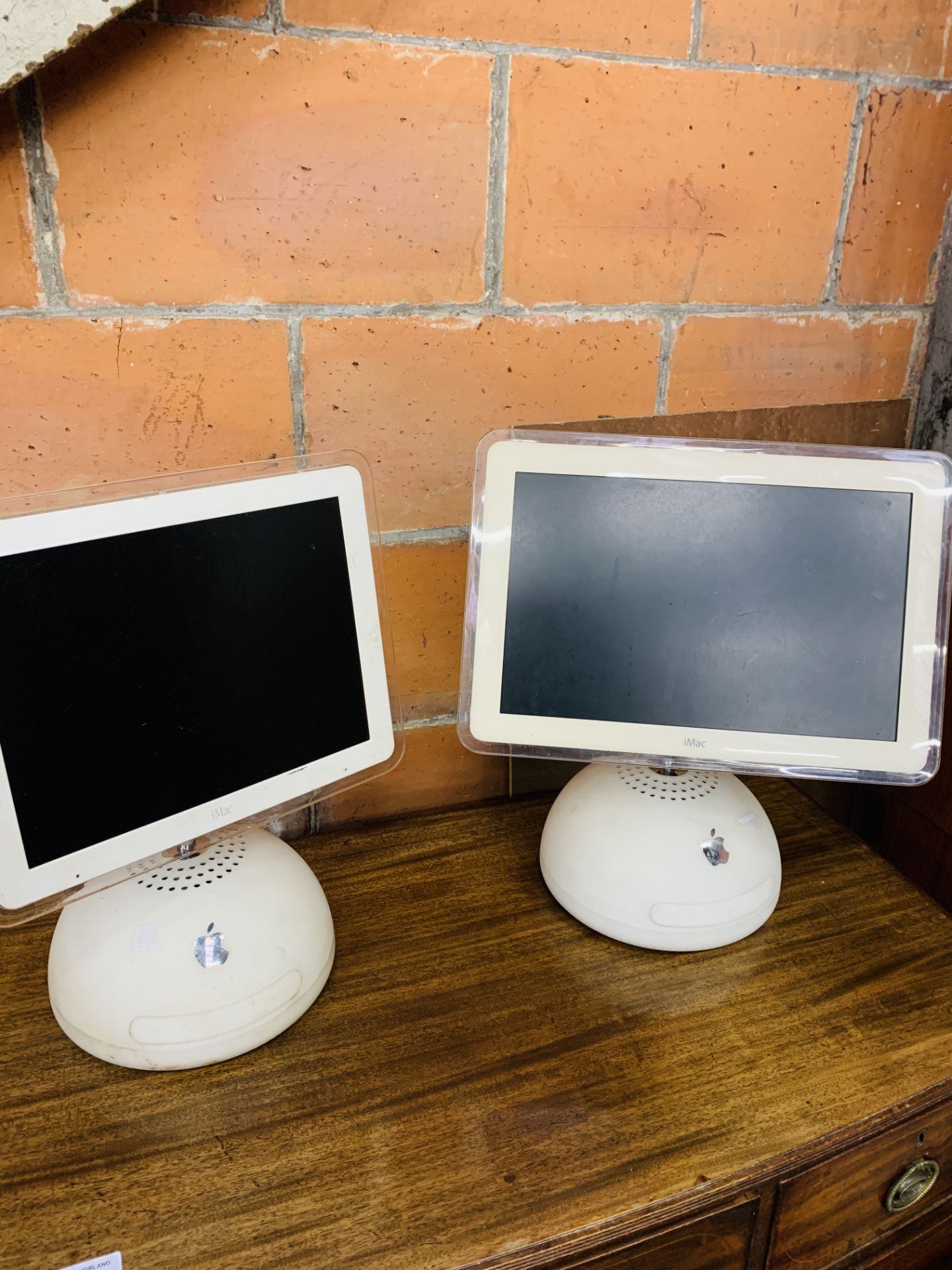 Two Apple iMacs.