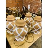 Two pairs of terracotta table lamps.