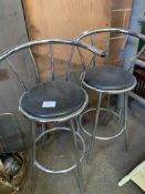 Two chrome and black leather effect bar chairs.