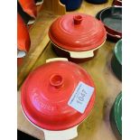 Two red Le Creuset casserole dishes.