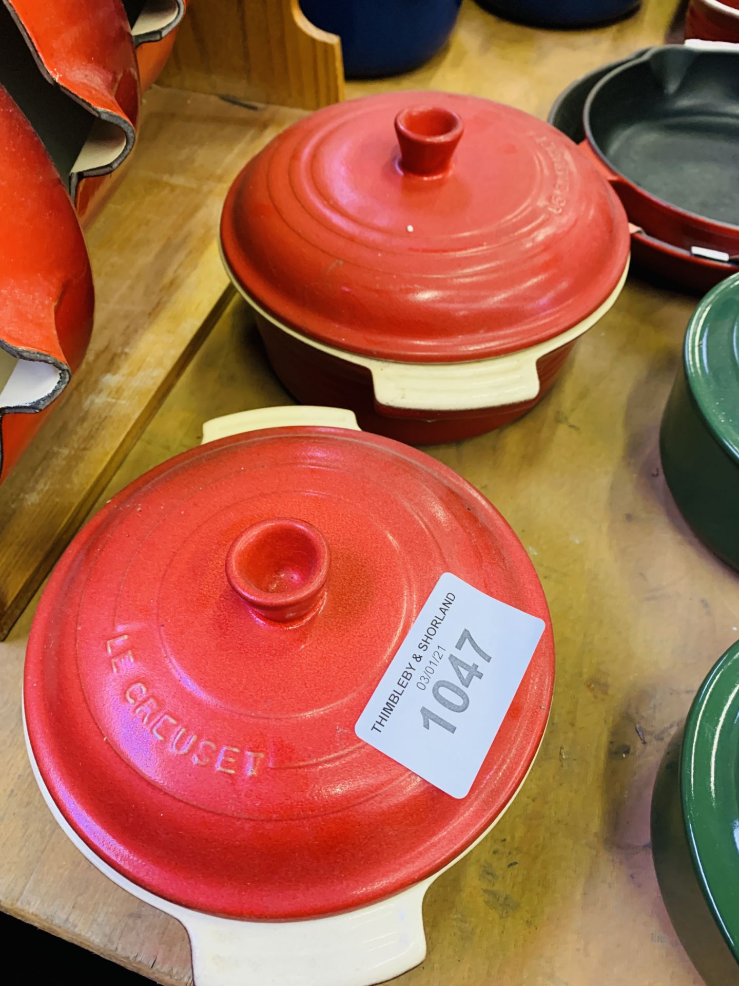 Two red Le Creuset casserole dishes.