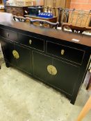 Oriental style sideboard with three frieze drawers over two cupboards.