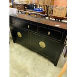 Oriental style sideboard with three frieze drawers over two cupboards.