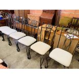 Six metal framed dining chairs with cream upholstered seats.