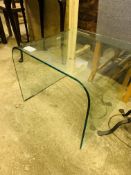 Curved glass display table.