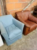 Small armchair upholstered in blue loose cover, and a brown leather armchair.