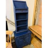 Pine computer desk together with a dark blue painted pine cabinet and pine open book shelves.