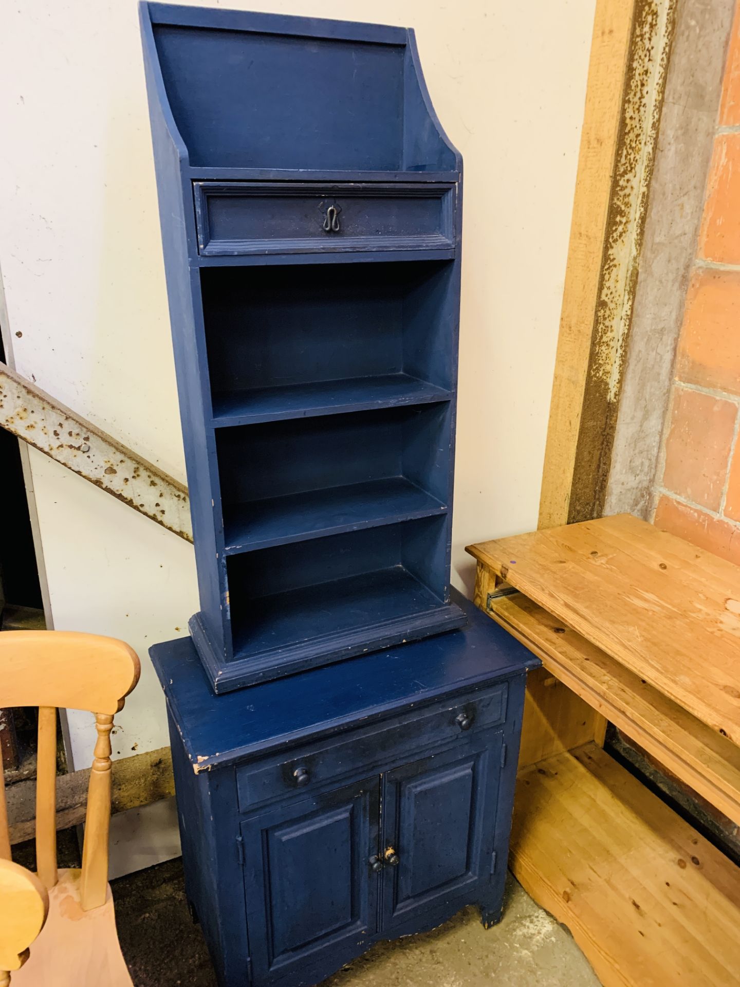 Pine computer desk together with a dark blue painted pine cabinet and pine open book shelves.