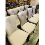 Eight fabric covered shaped back dining chairs.
