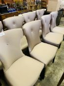 Eight fabric covered shaped back dining chairs.