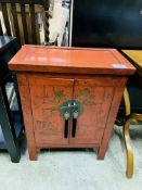 Oriental style cabinet with brass lock and handles.