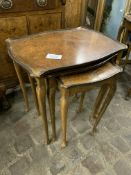 Nest of three walnut shape-sided tables.