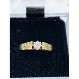9ct gold diamond ring with patterned shoulders.