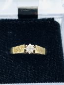 9ct gold diamond ring with patterned shoulders.