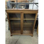 Mahogany bow fronted book case with three shelves, glass fronted doors, key.