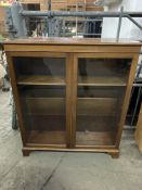 Mahogany bow fronted book case with three shelves, glass fronted doors, key.