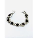 925 silver bracelet with red stones.