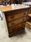 Hardwood small chest of three drawers, and a cane seat bedroom chair.