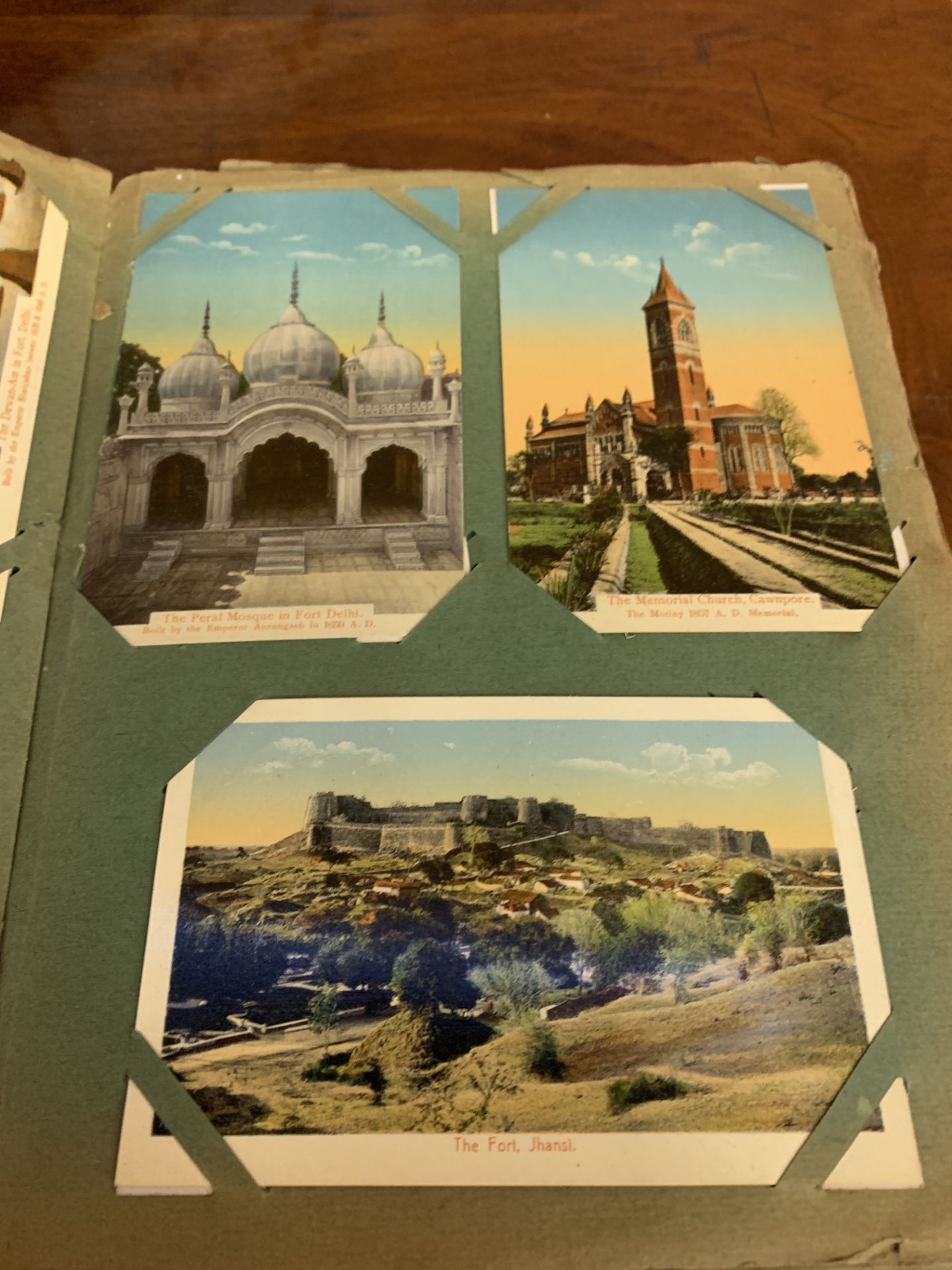 Old album containing various postcards.