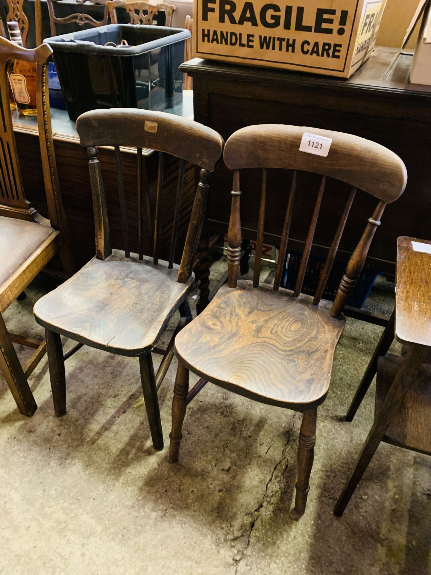 Two elm seat comb back kitchen chairs.