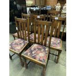 Five oak framed rail back dining chairs, matching carver, and another carver.