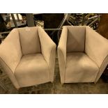 Two suede upholstered tub chairs.