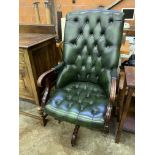 Green buttoned leather upholstered swivel chair.