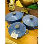 Three blue Le Creuset casserole dishes.