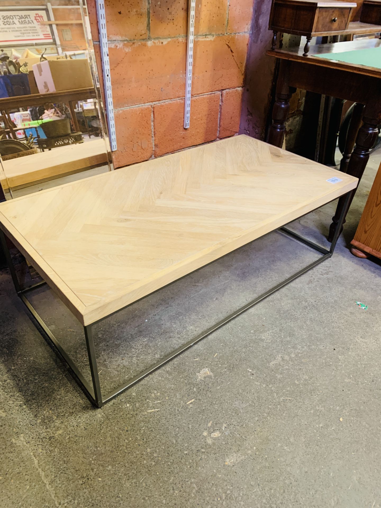 Hardwood coffee table on metal legs.