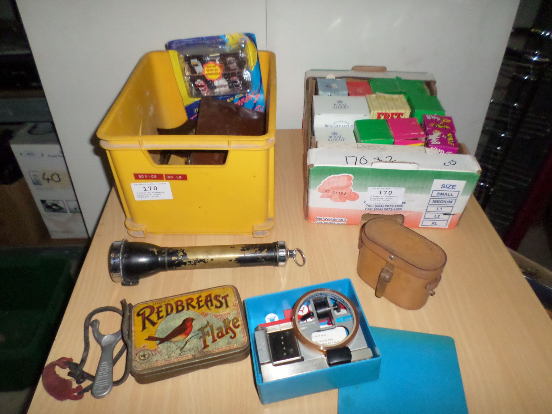 2 boxes of ornaments, binoculars, torch, lighters, coins