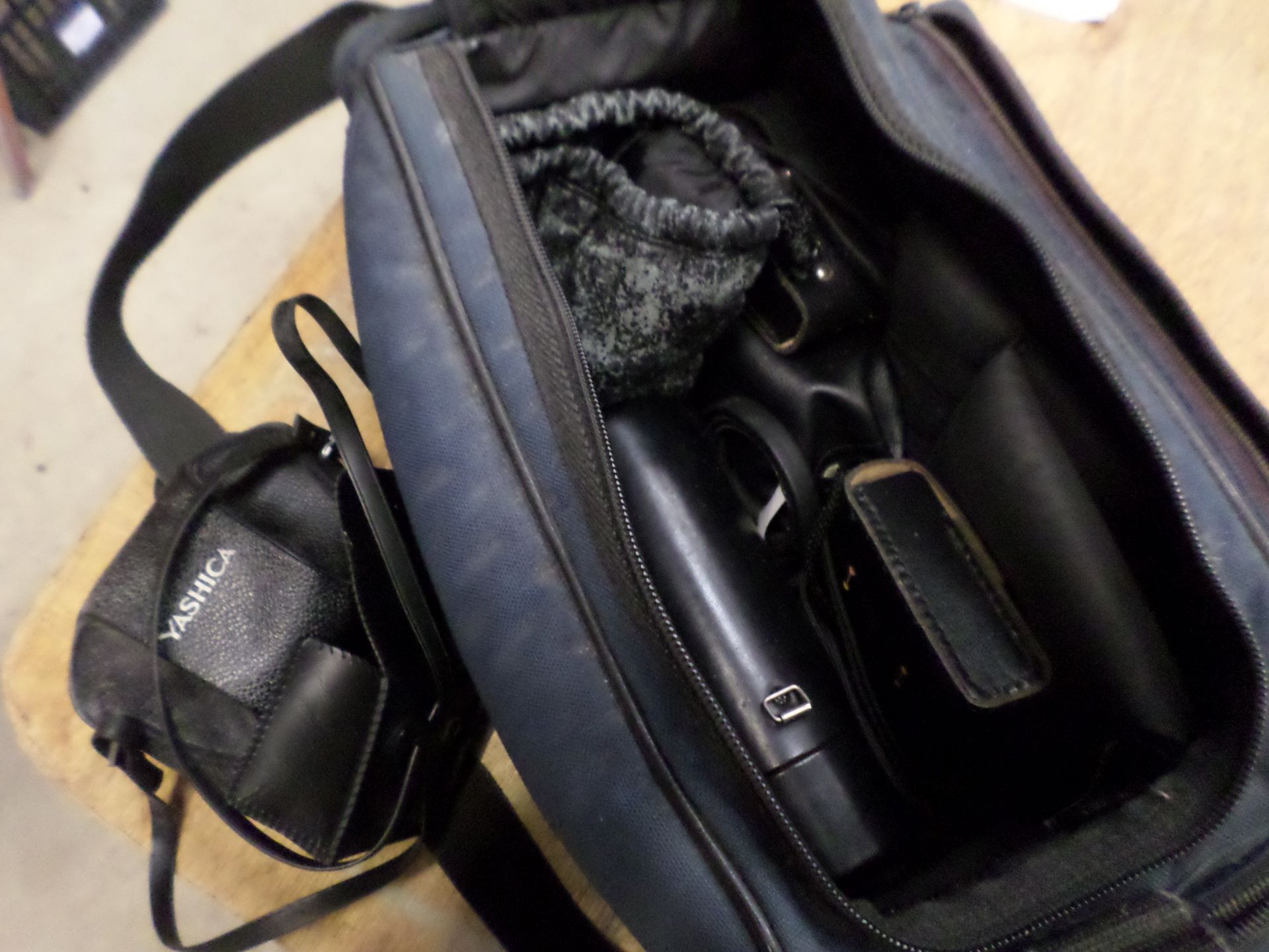 Camera bag with numerous lenses, light meter etc