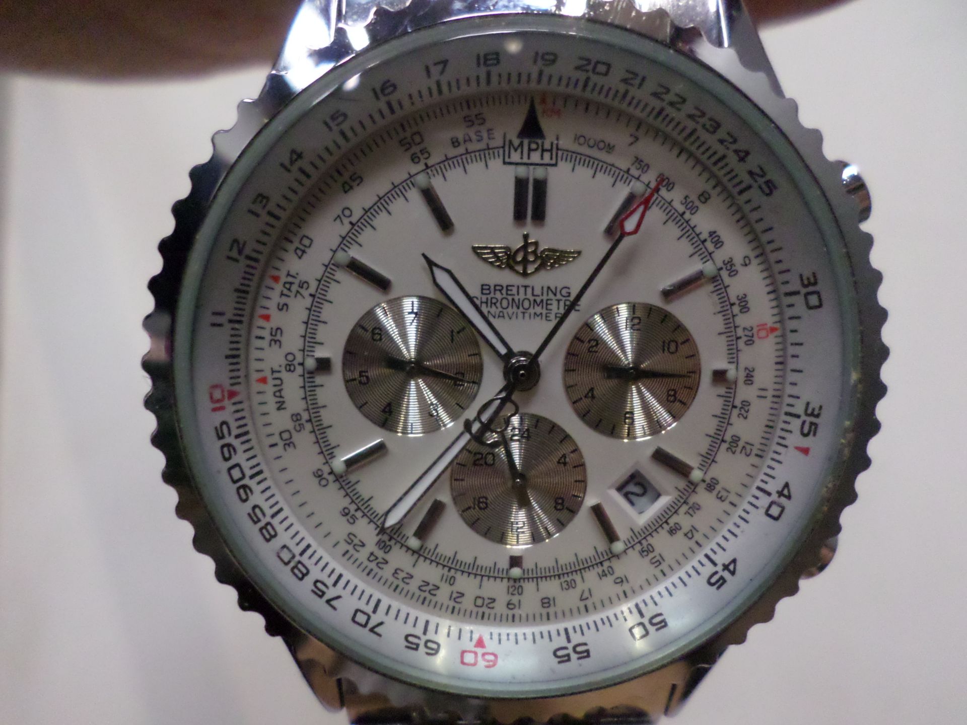 Stainless steel watch with Breitling marked on face, back and strap