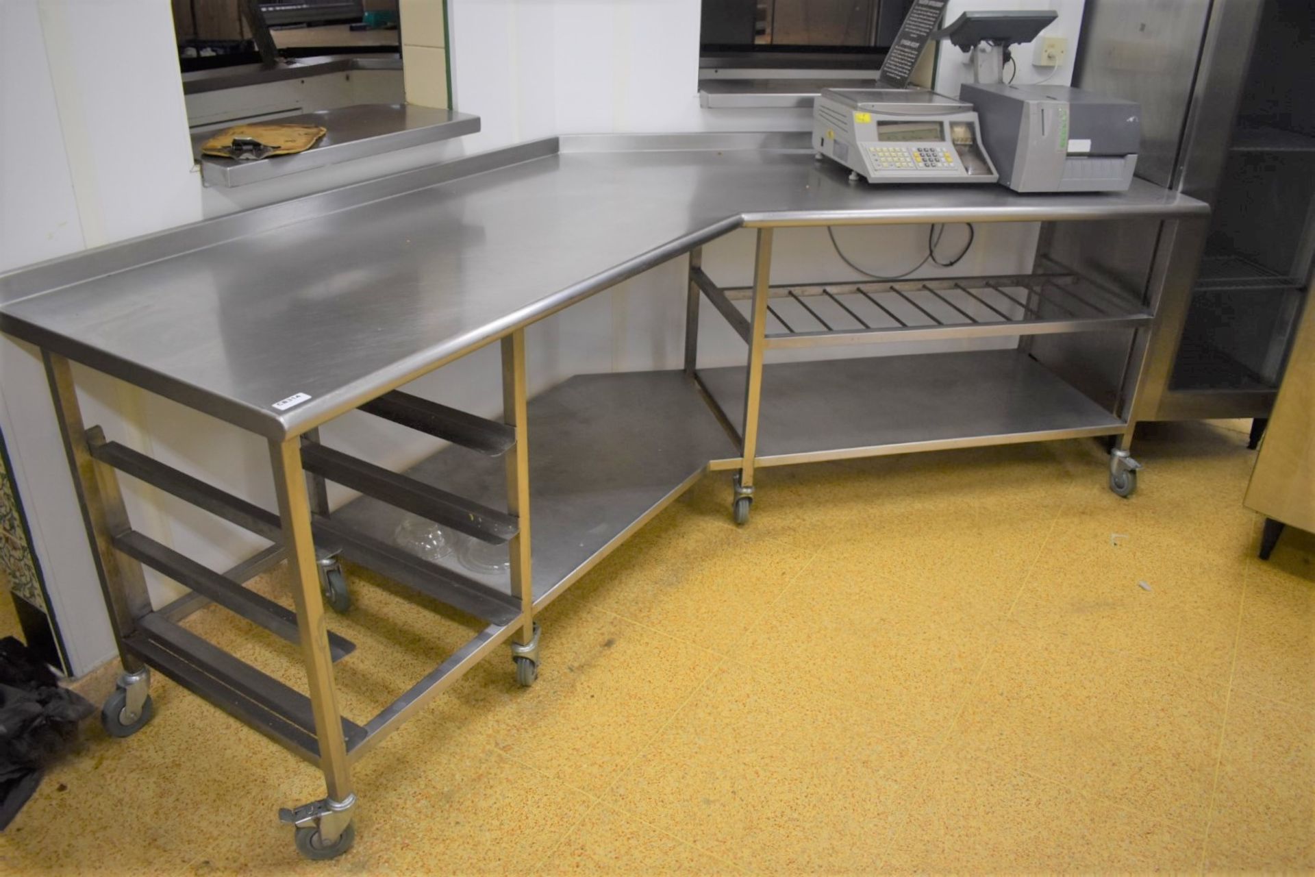 1 x Large Stainless Steel Corner Shaped Prep Table on Castors With Upstand, Undershelf, Tray Rails