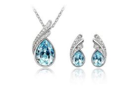 BRAND NEW TWO PIECE LADIES SET, INCLUDING NECKLACE AND EARRINGS, SET WITH BLUE CRYSTALS AND WHITE