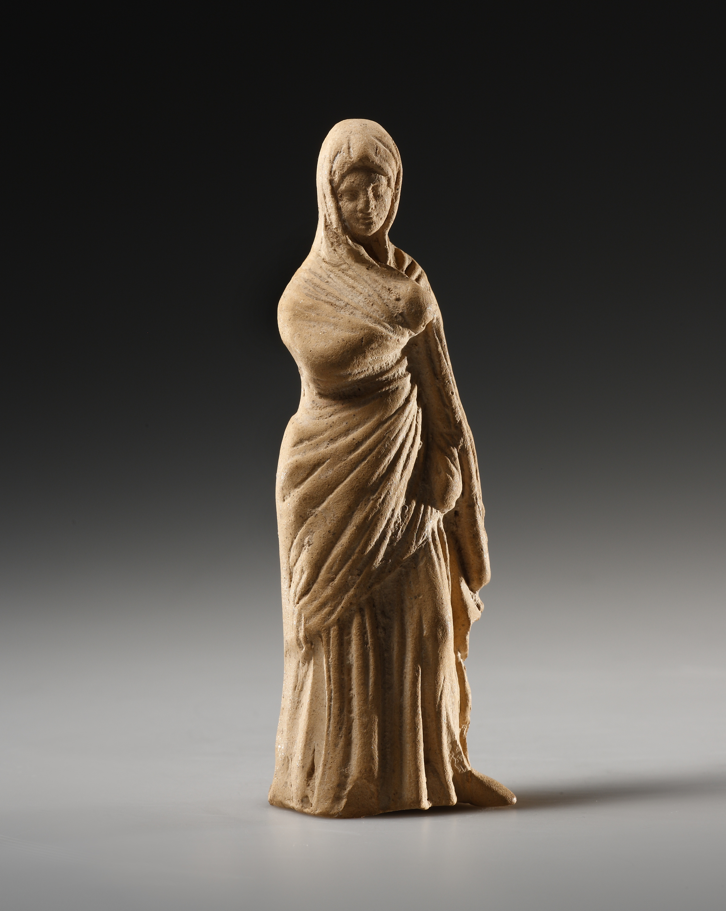 A Small Statuette of a Draped Female