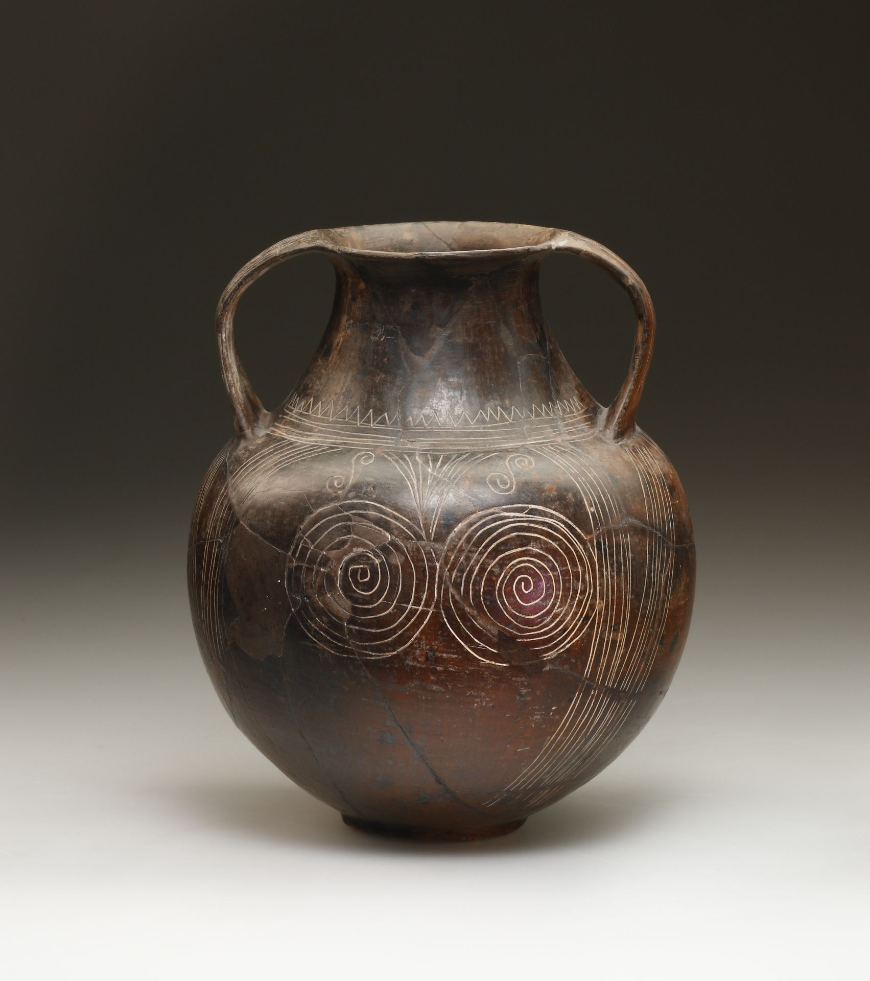 An Etruscan Impasto Amphora with Incised Geometric and Spiral Decoration