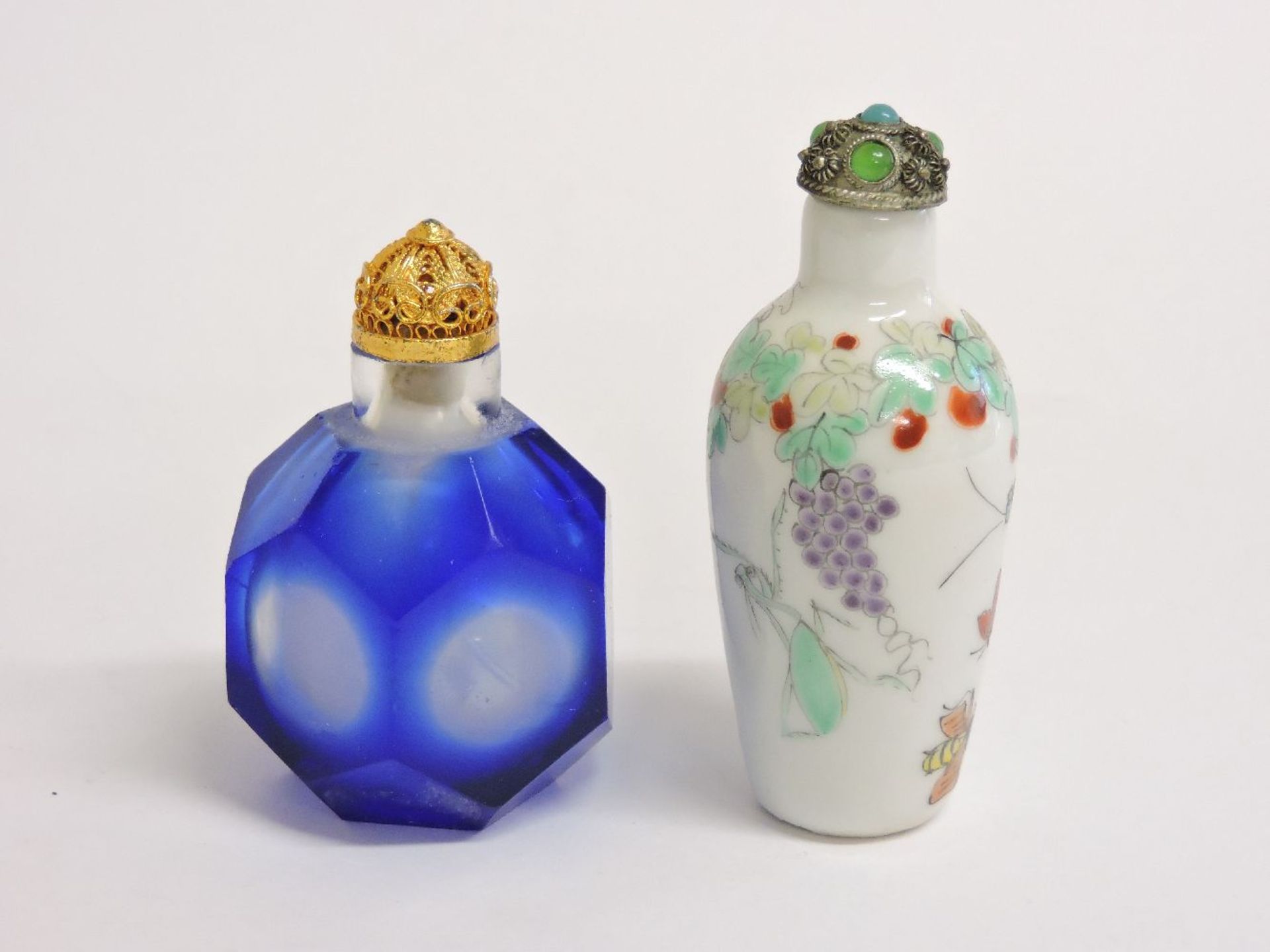 Two Chinese snuff bottles and stoppers, one porcelain painted in enamels, with fruit and insects,