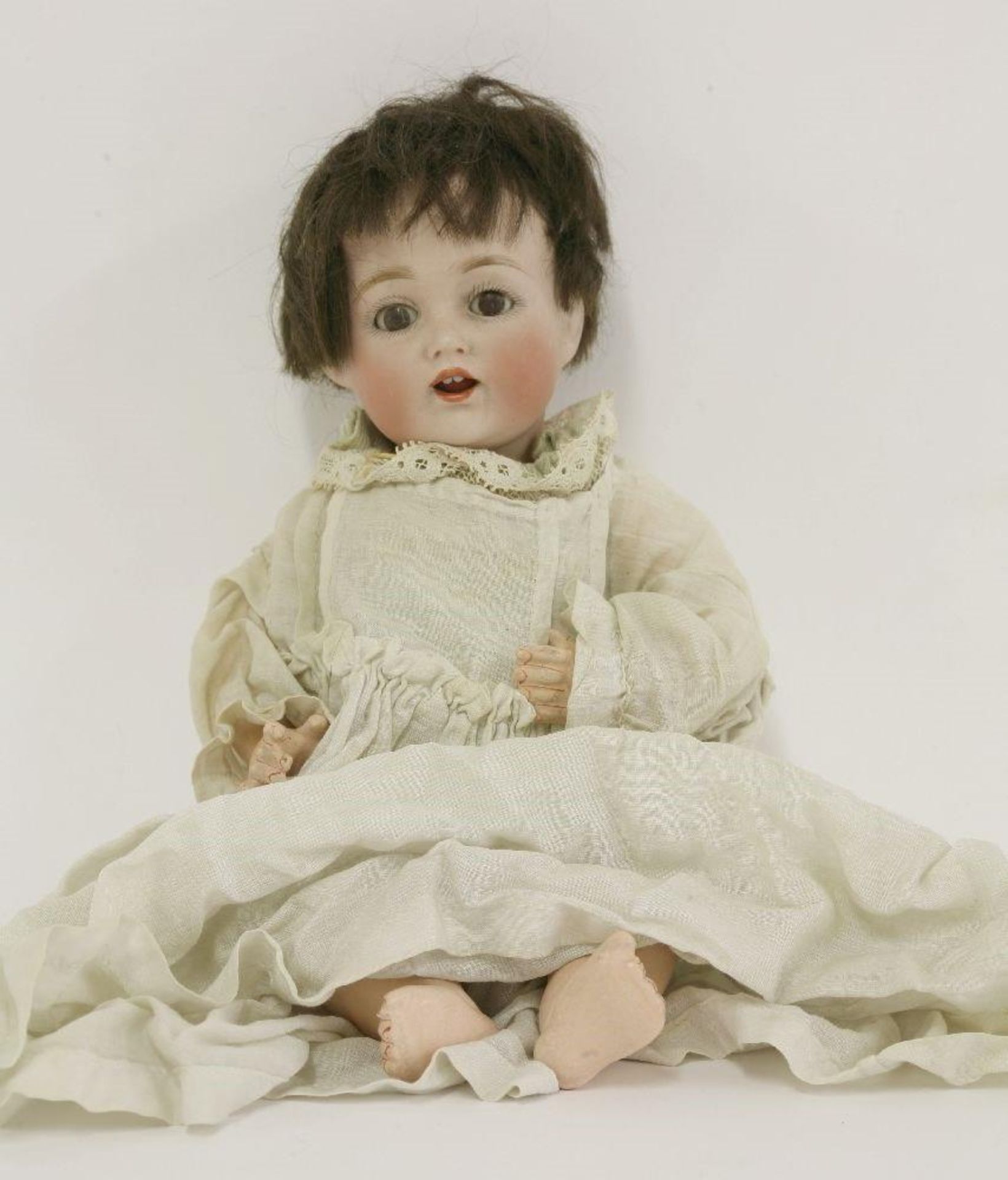 A German bisque head doll, 24cm high