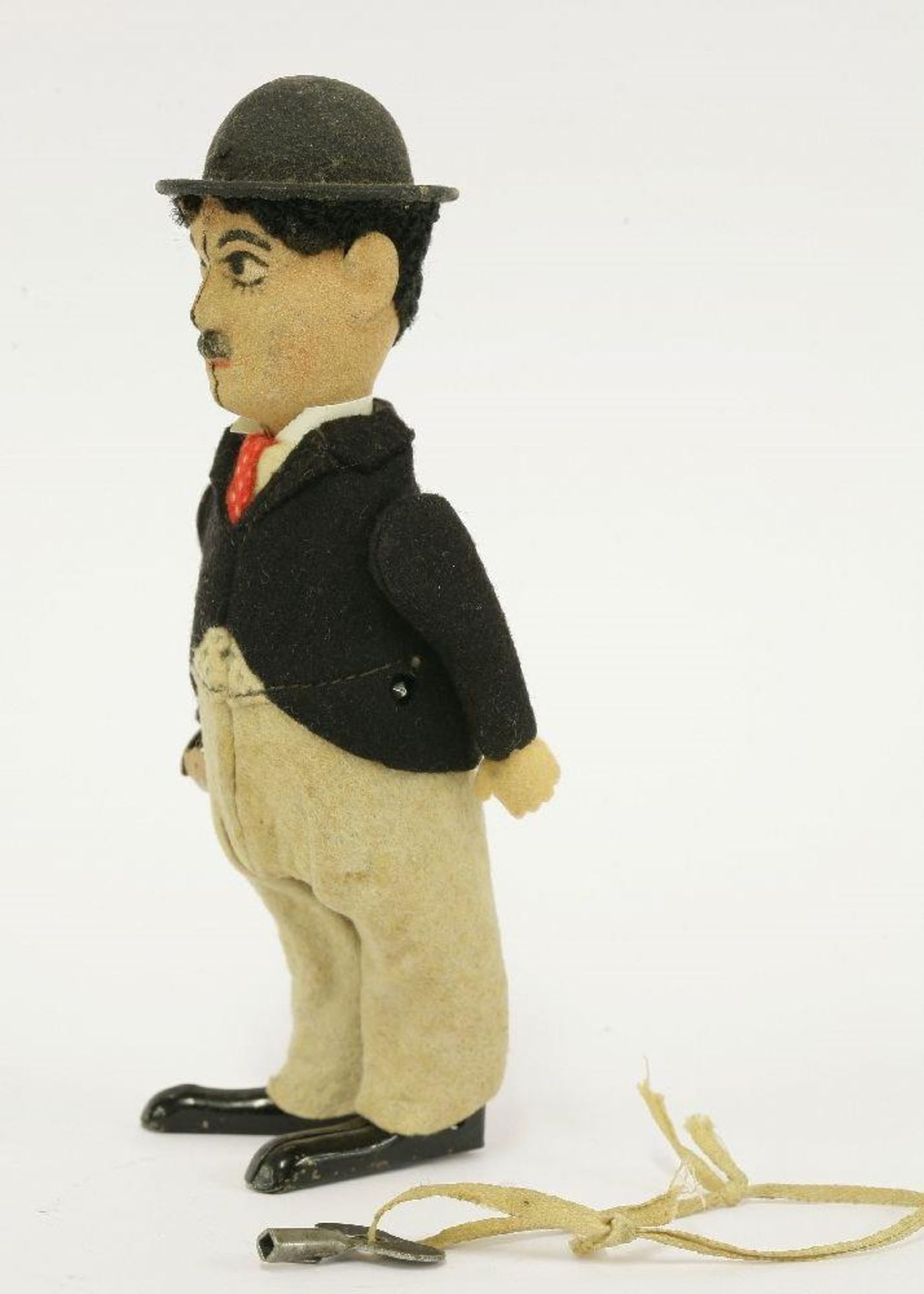 A Schuco Charlie Chaplin tinplate clockwork figure, in a black felt jacket with grey trousers and - Bild 2 aus 2