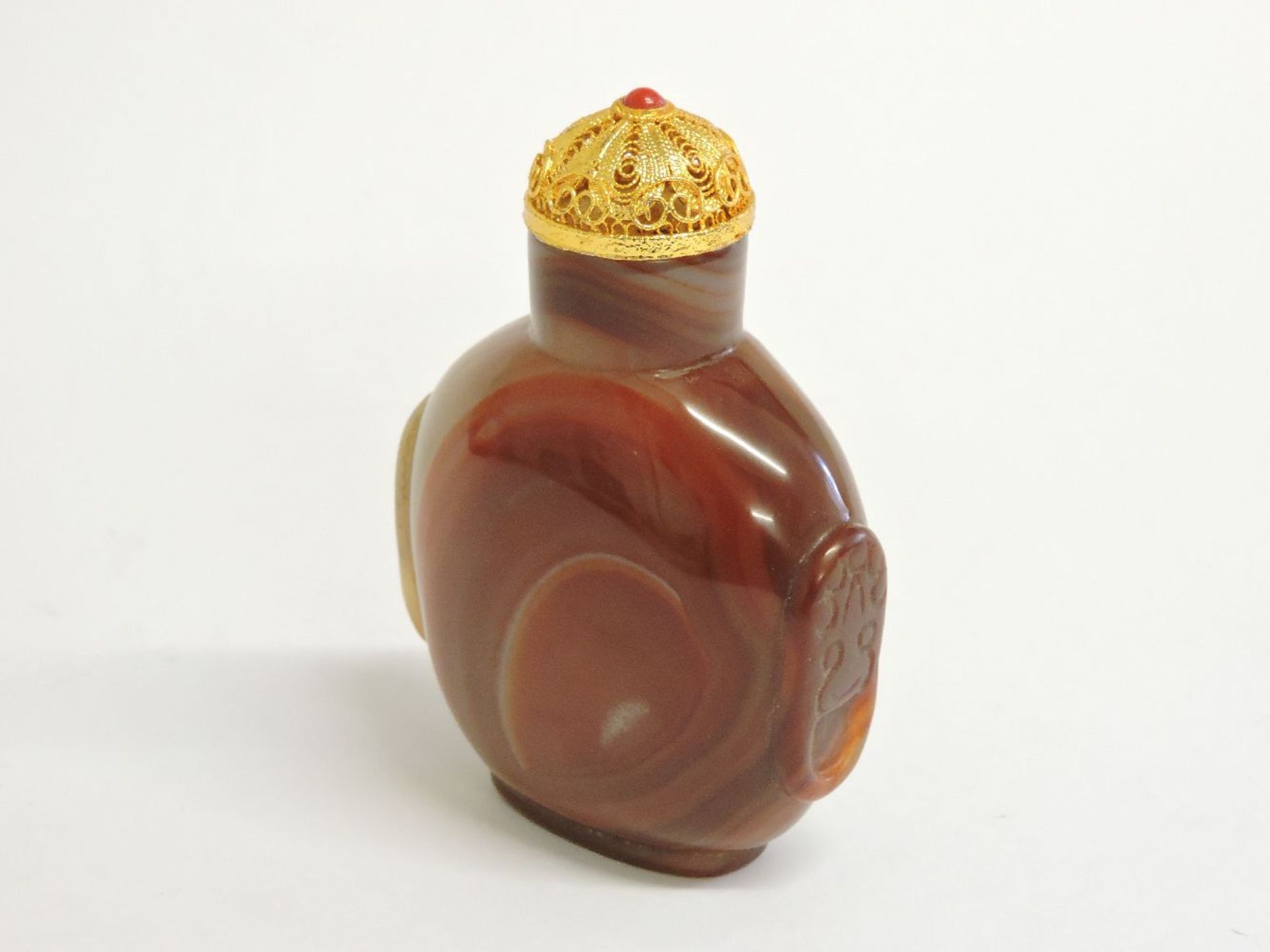 A large Chinese agate snuff bottle and stopper, with agate style decoration, 9cm high