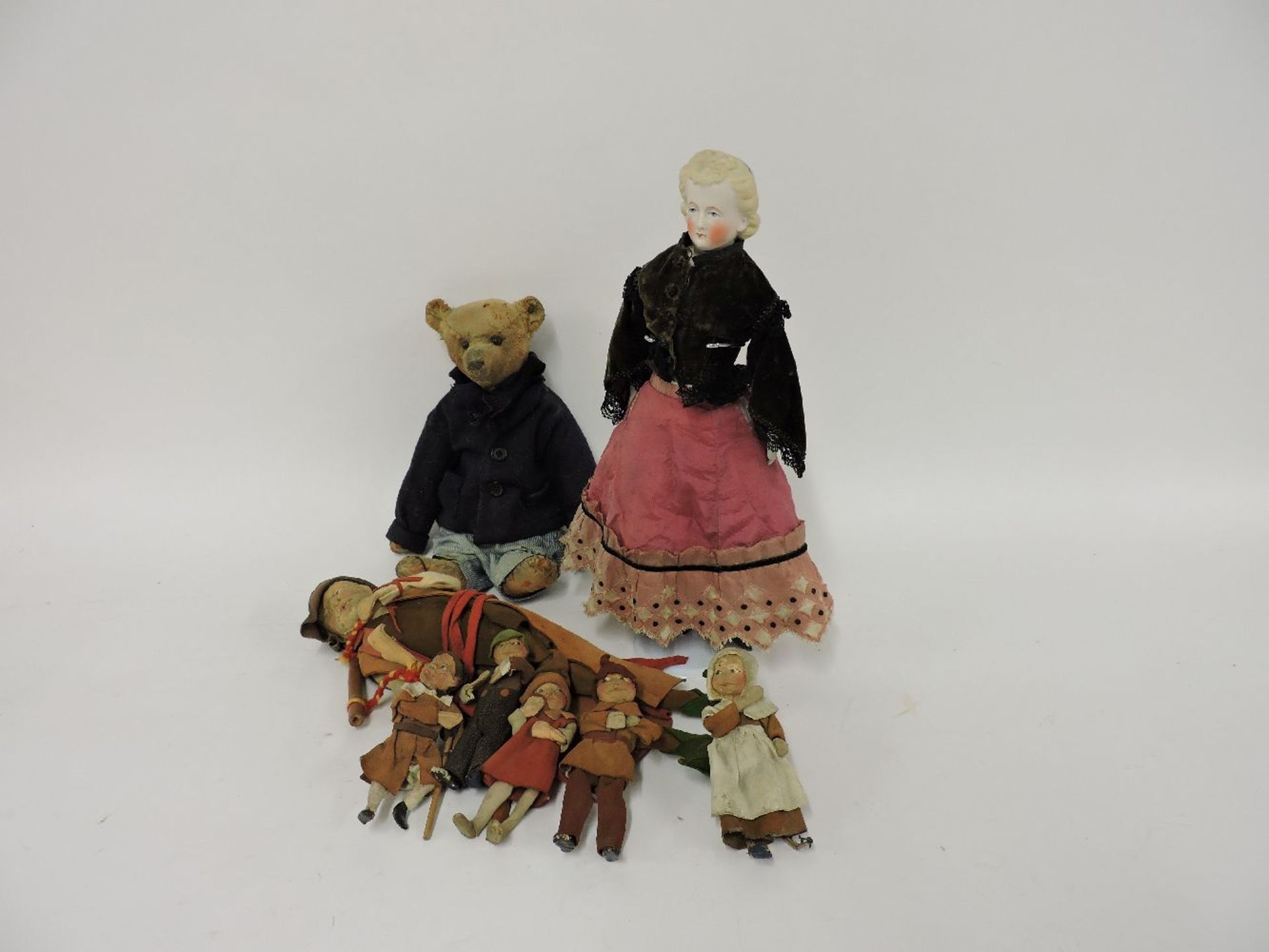 A Steiff bear, wearing a jacket and pinstripe trousers, a pressed leather Pied Piper with six