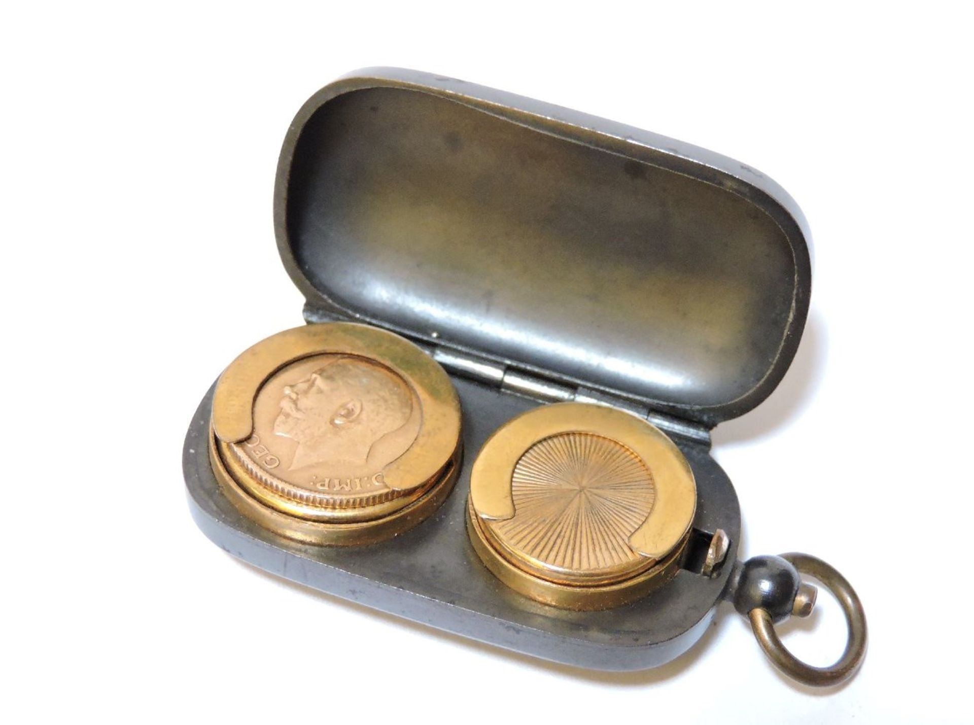 A George V gold sovereign 1911, within a gunmetal sovereign case with gilt interior