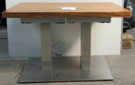 Polished wooden table with steel plated legs